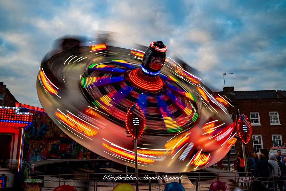 Light trails from a fairground ride at dusk